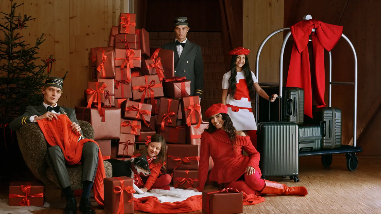 Christmas presents and a cup of hot chocolate on a fluffy hotel bed