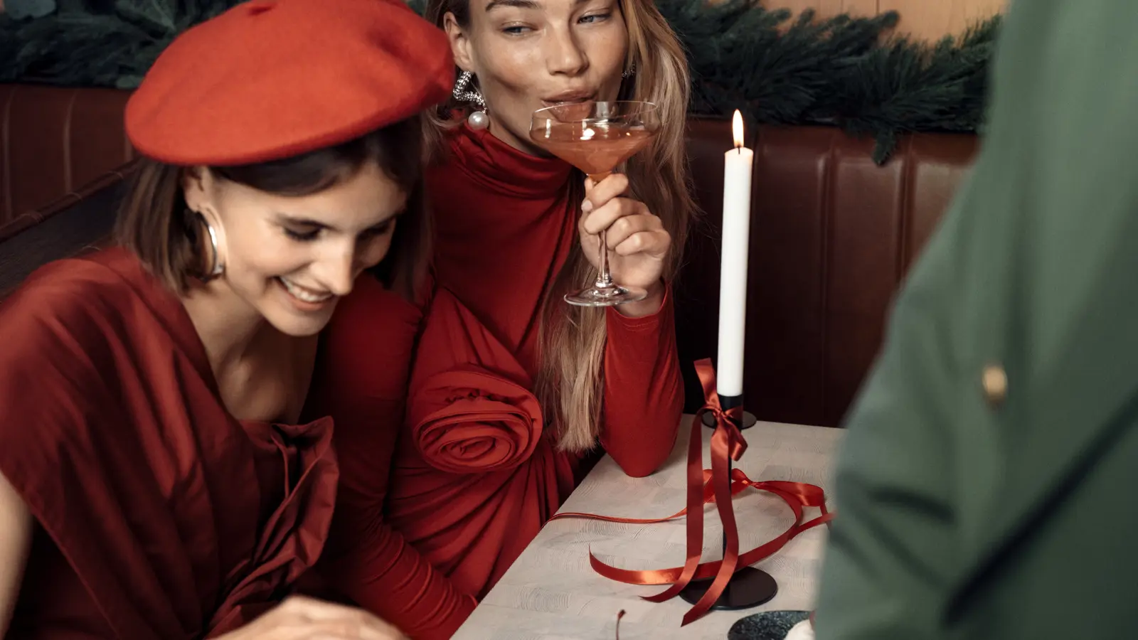 Two people at the dinner table, each with a plate and a glass of wine