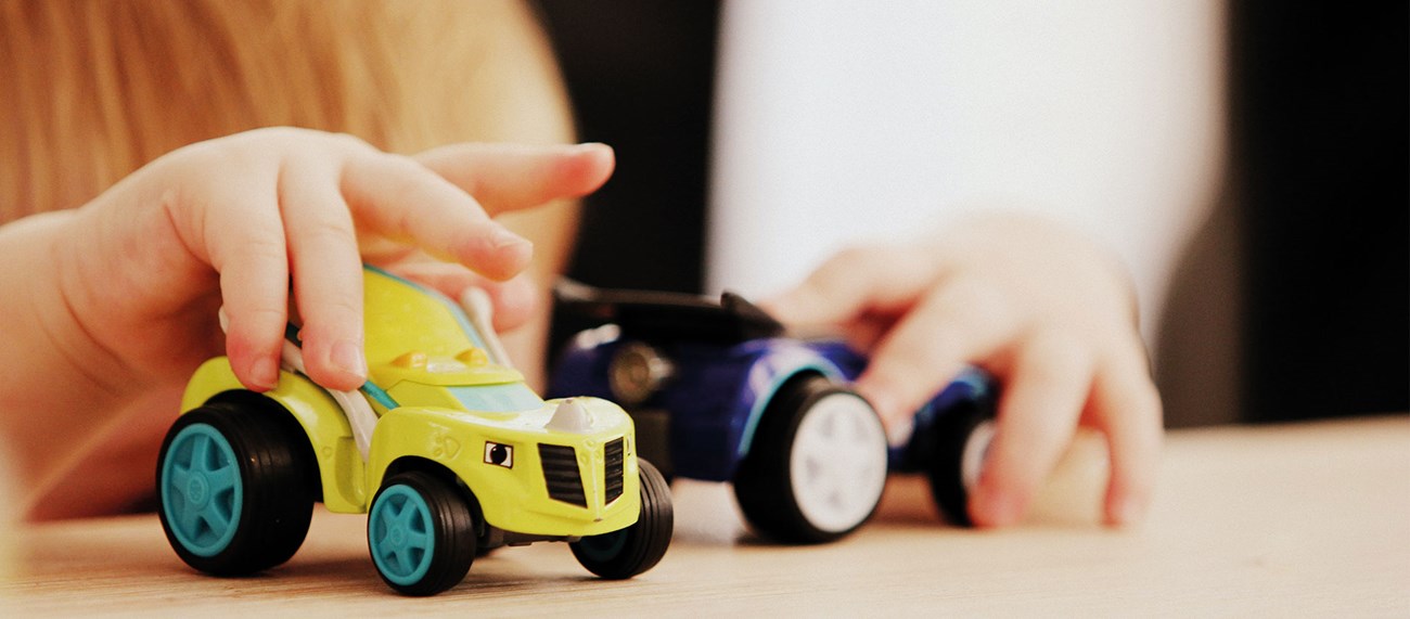 Ett barn som leker med leksaksbilar