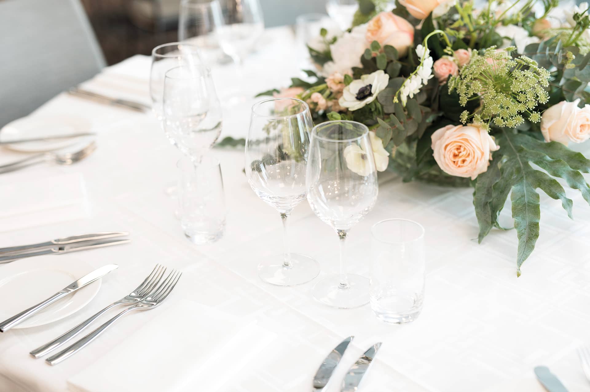 Bright rustic room with round restaurant tables and cozy lighting