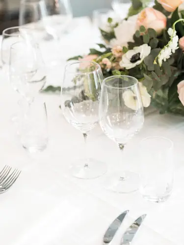 Bright rustic room with round restaurant tables and cozy lighting