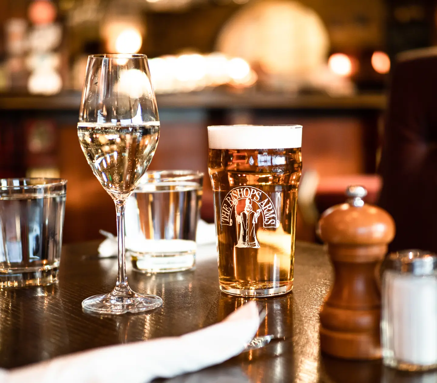 Filled beer and wine glasses standing on table