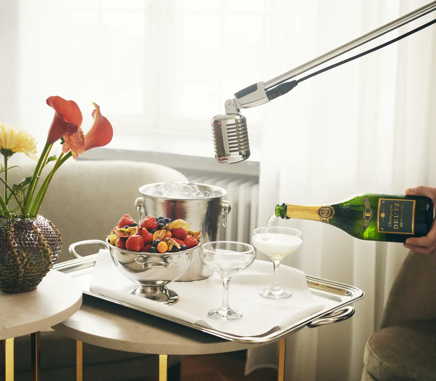 Vip served on table with bouquet, champagne being poured and microphone over
