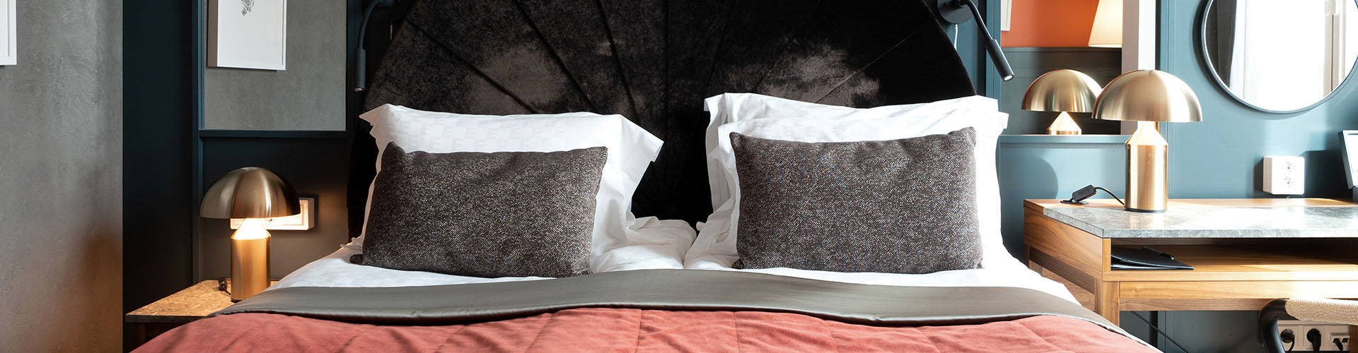 A hotel bed with a desk