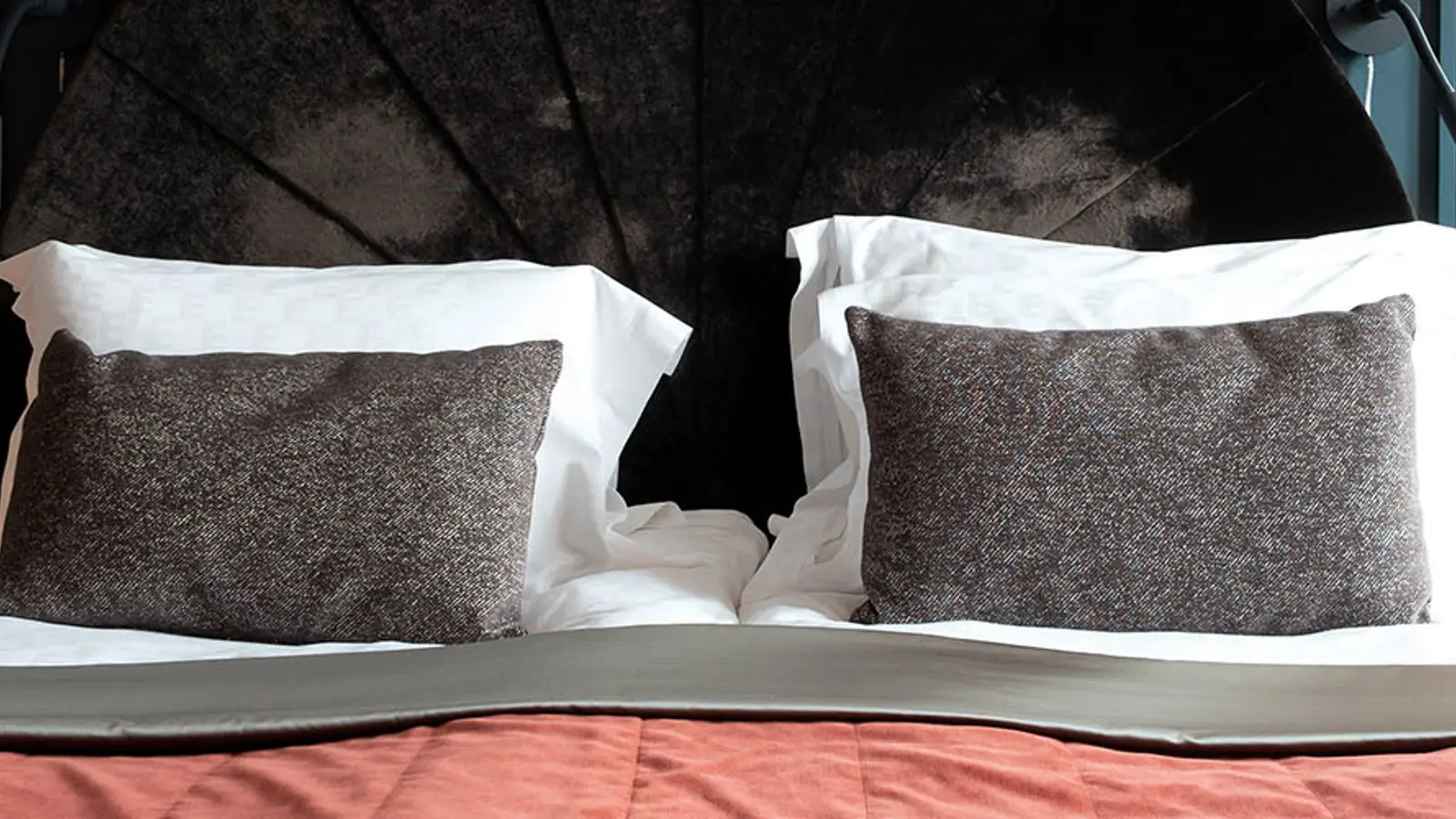 A hotel bed with a desk