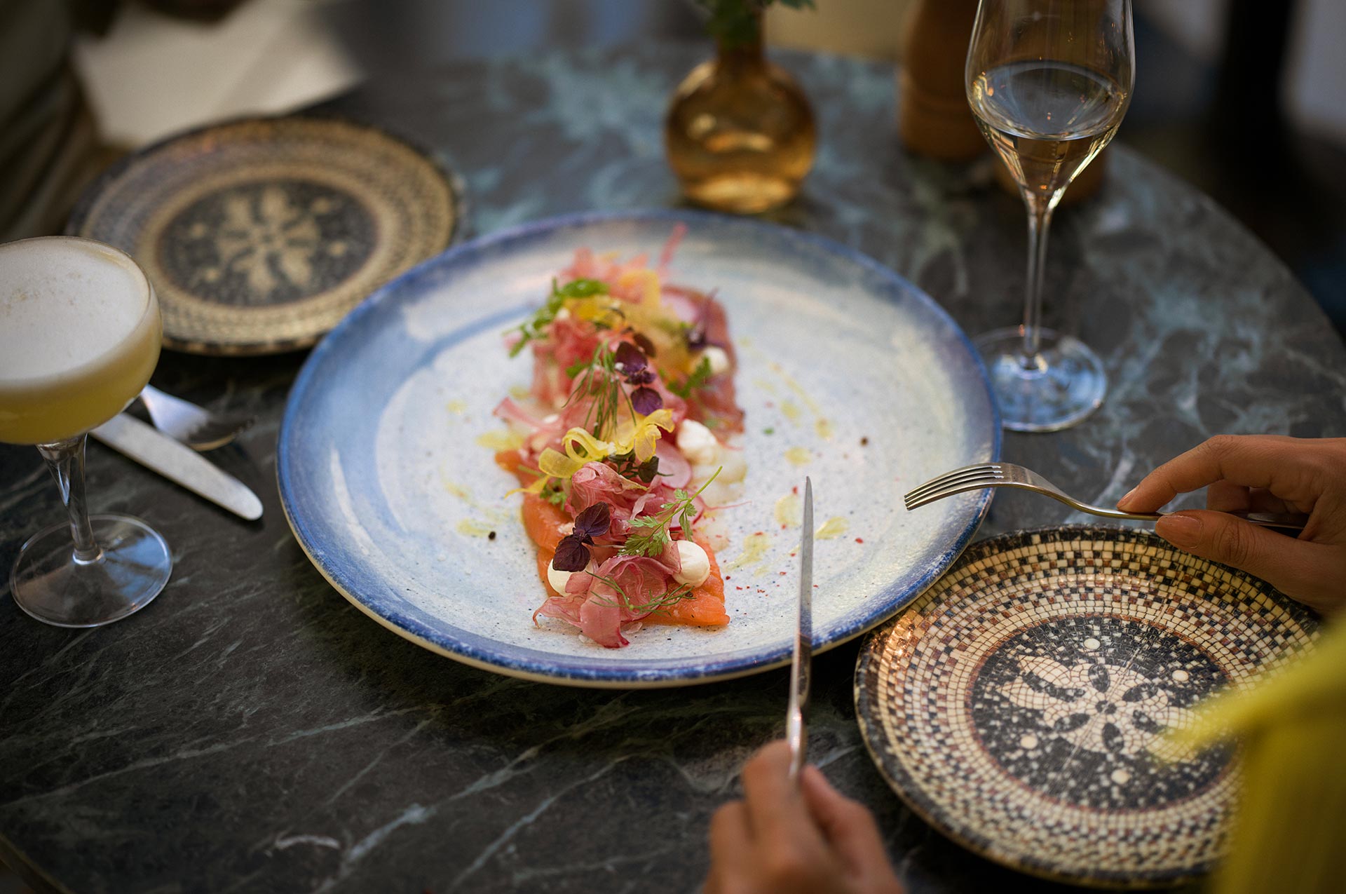 Set table with a beautiful salmon dish and drink