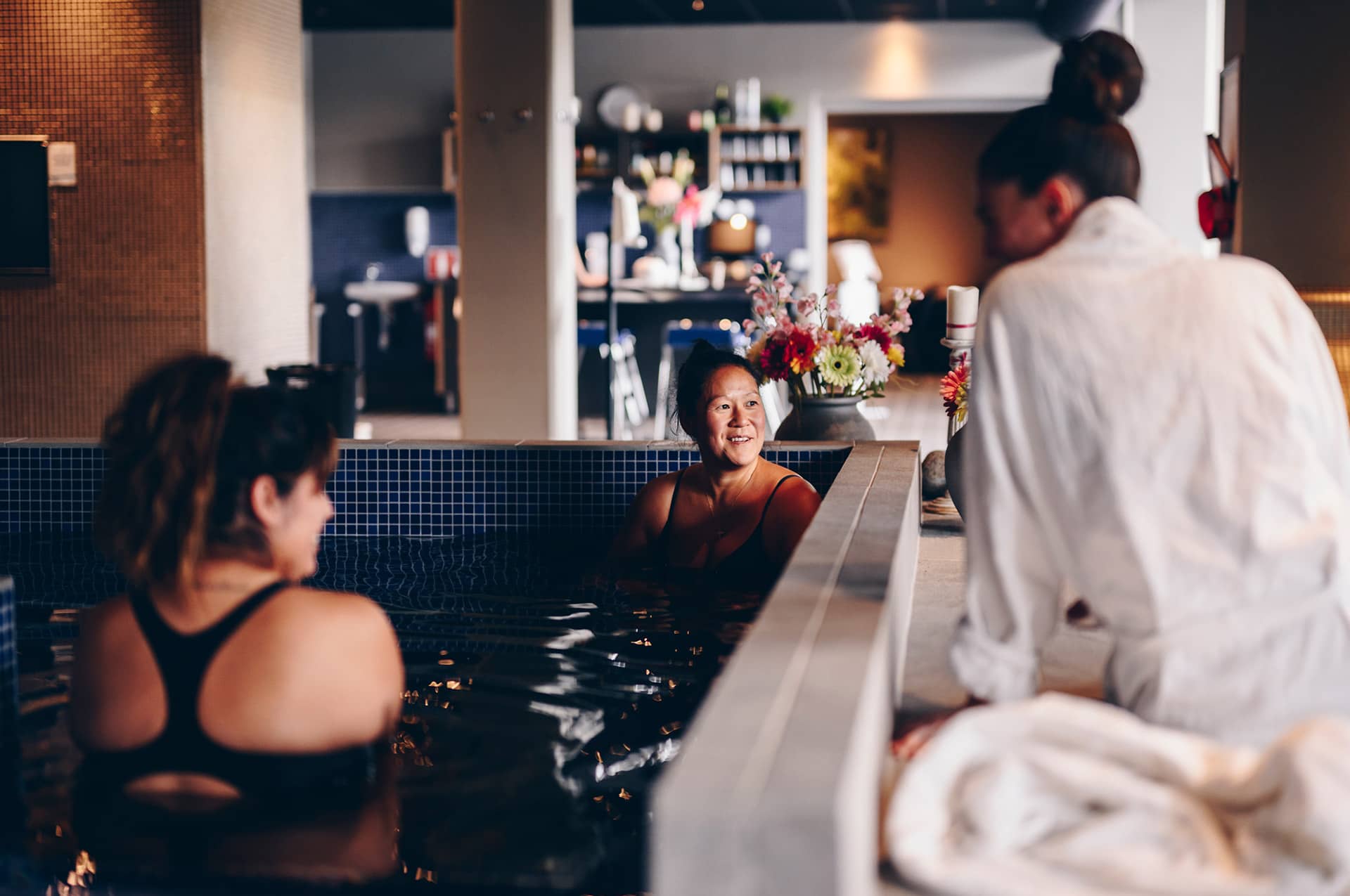 Three women hanging out in a pool at a relaxation area