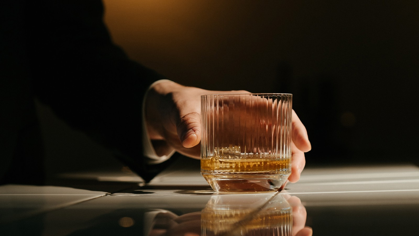A man holding a whiskey glass