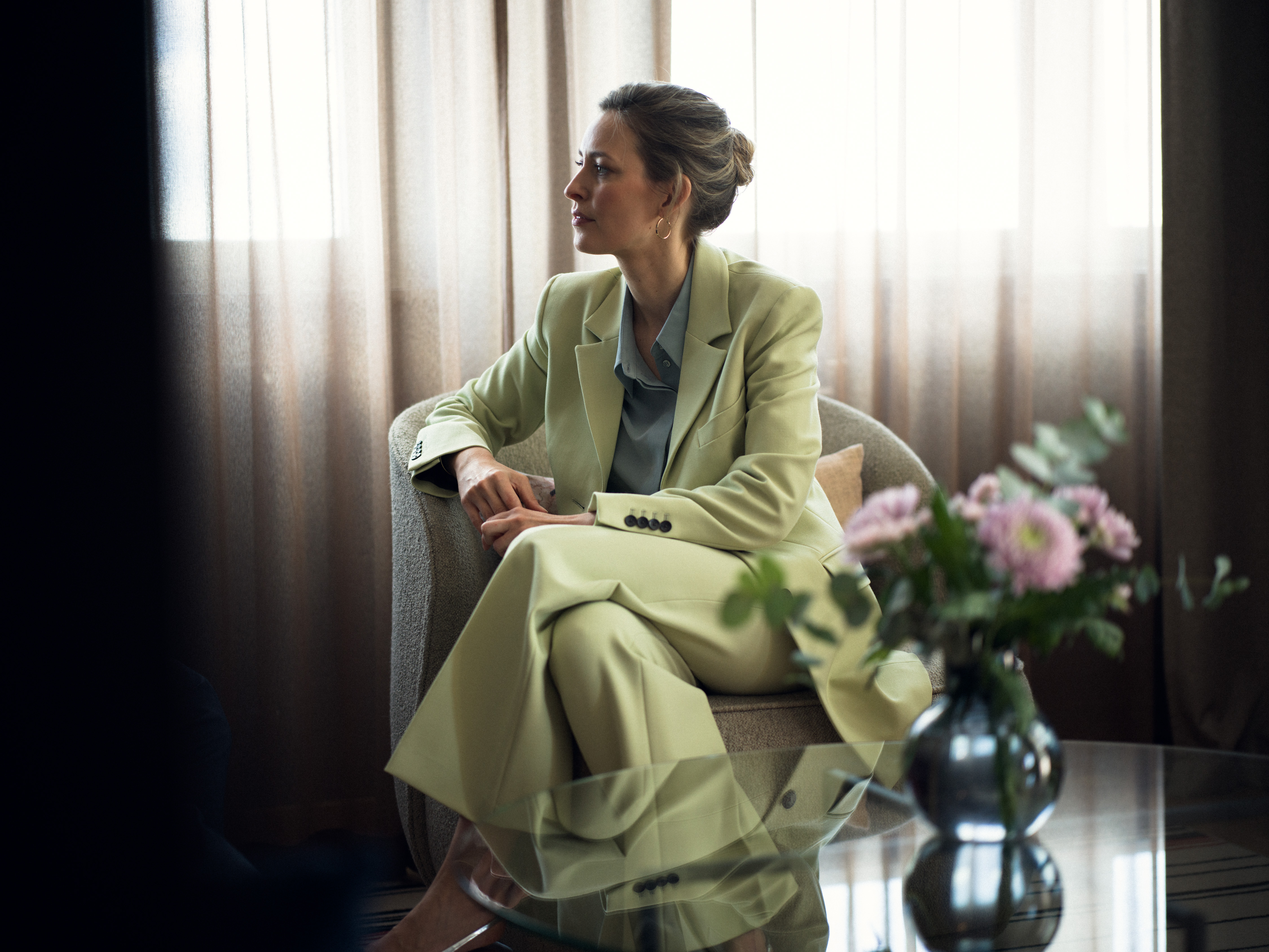 A woman sitting on a conference stage