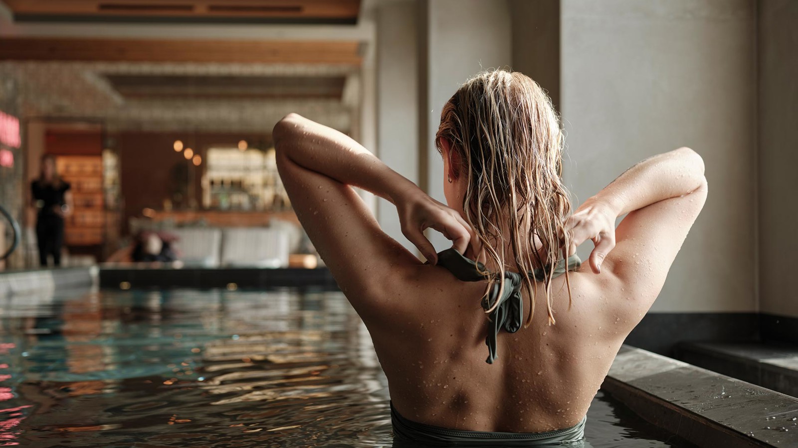 Woman standing with her back to in a pool