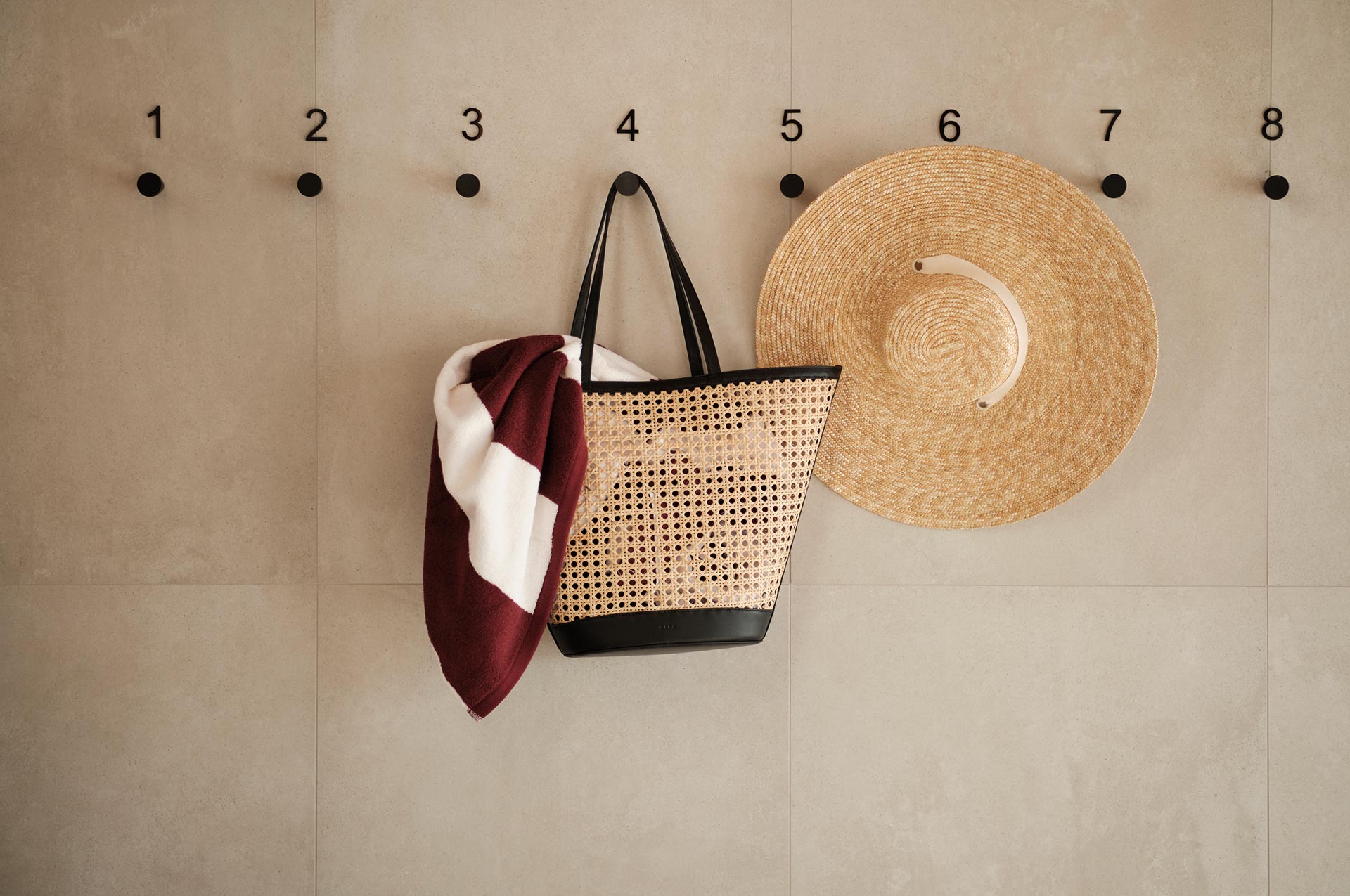 Straw hat, bag and towel hung on the wall