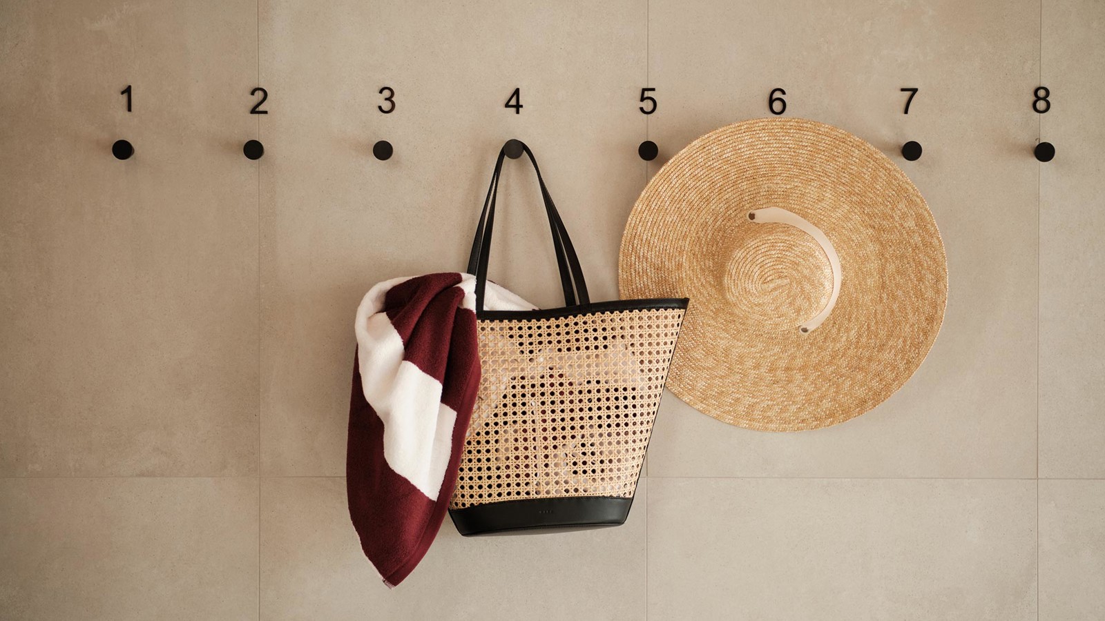 Straw hat, bag and towel hung on the wall