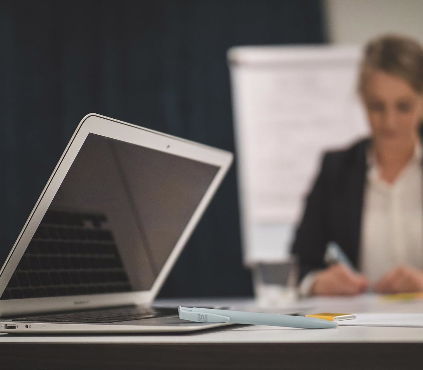 A woman at a desk with a computer