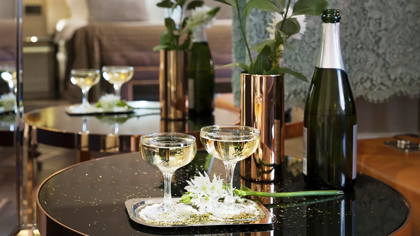 Tray of Champagne in front of a bed in a hotel room