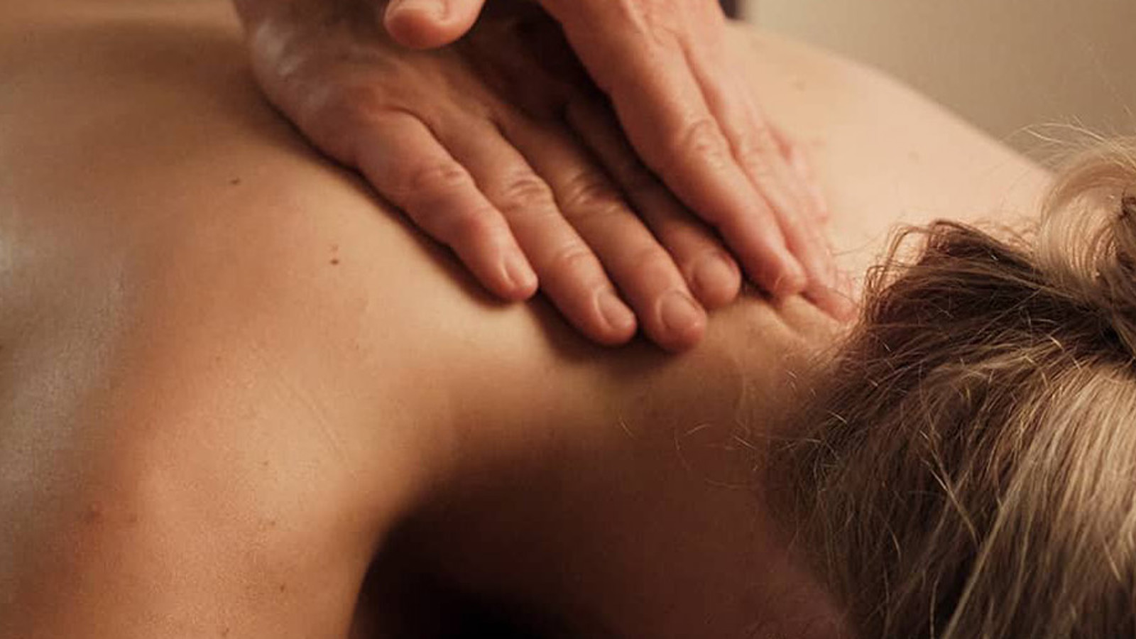 A woman being massaged at a spa