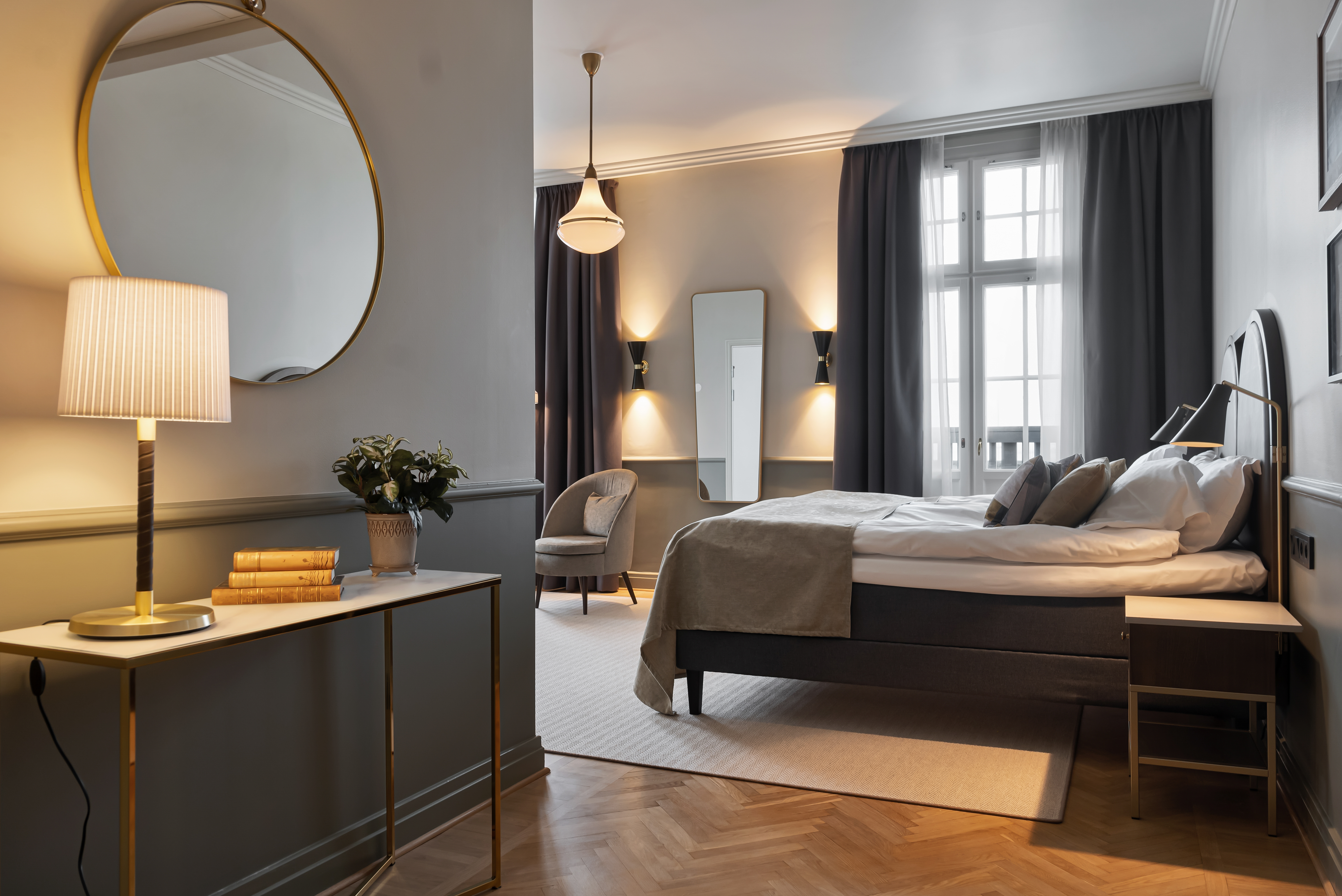 A hotel room with a double bed and a desk