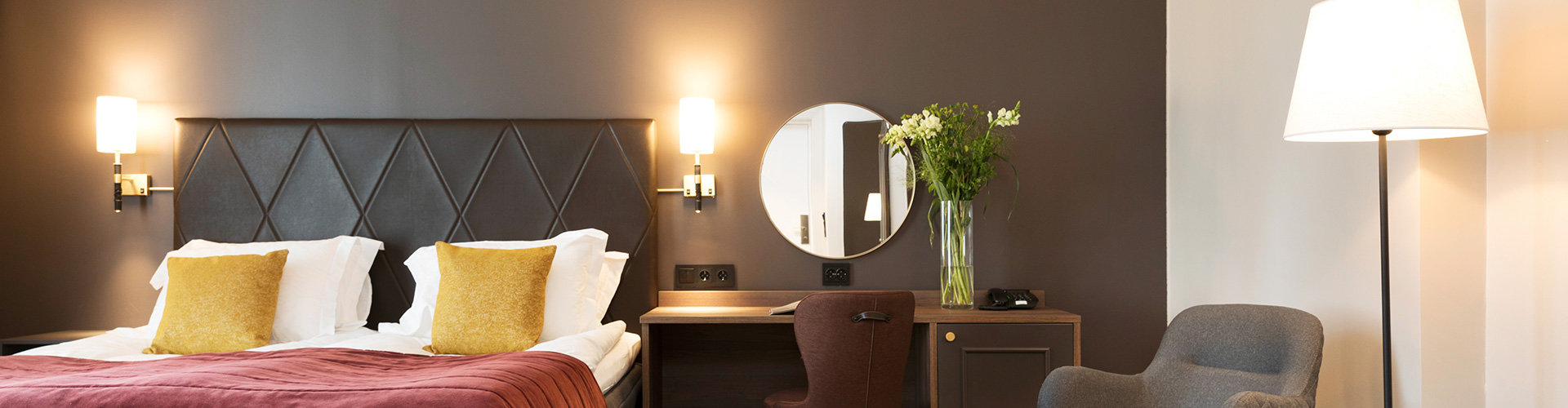 A double room with an armchair and desk