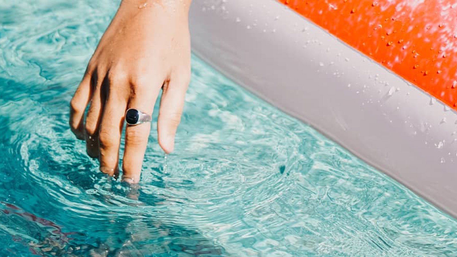 Hand dipping fingers in a pool