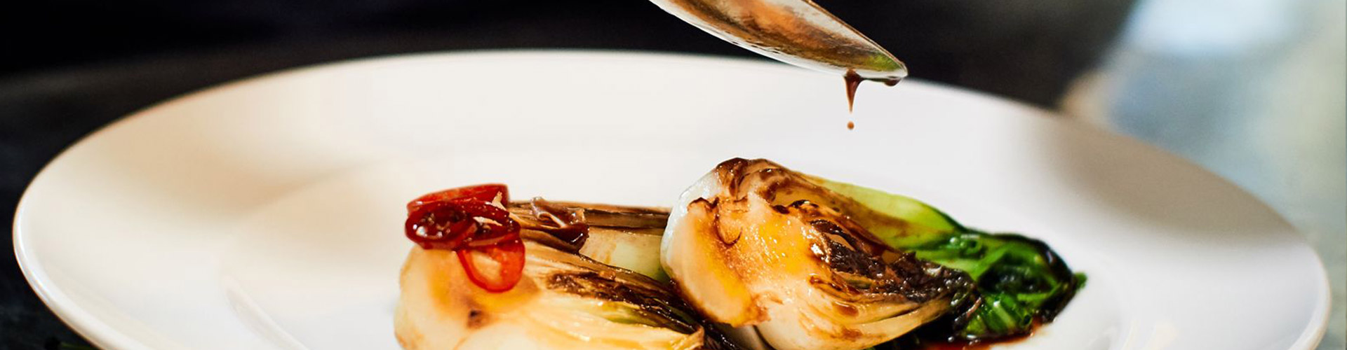 A finely plated dish consisting of cabbage with sauce