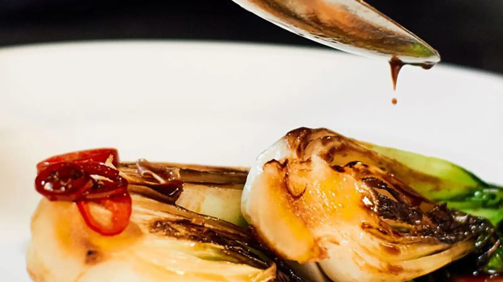 A finely plated dish consisting of cabbage with sauce