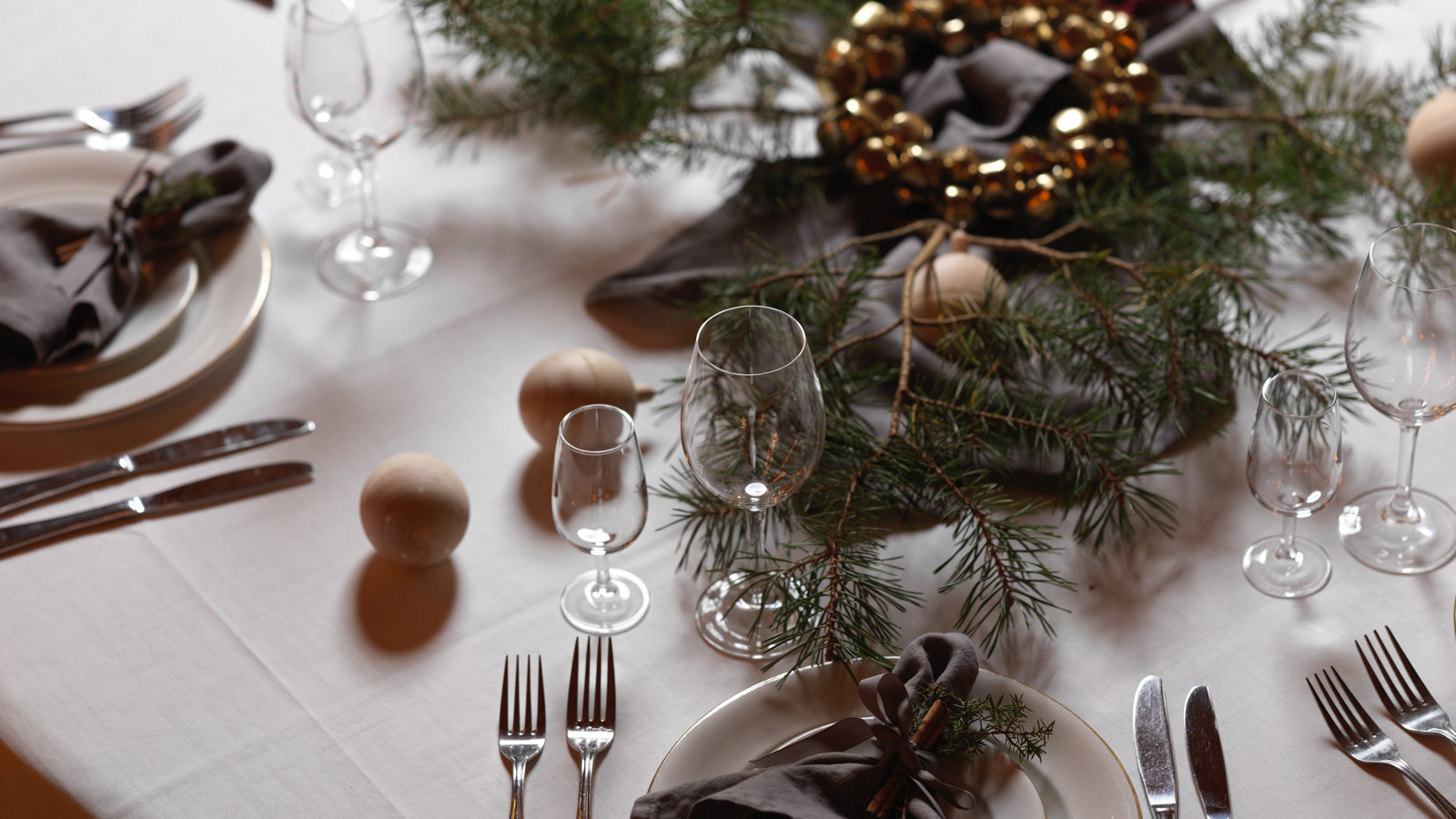 Beautiful Christmas table setting in green, brown and gold