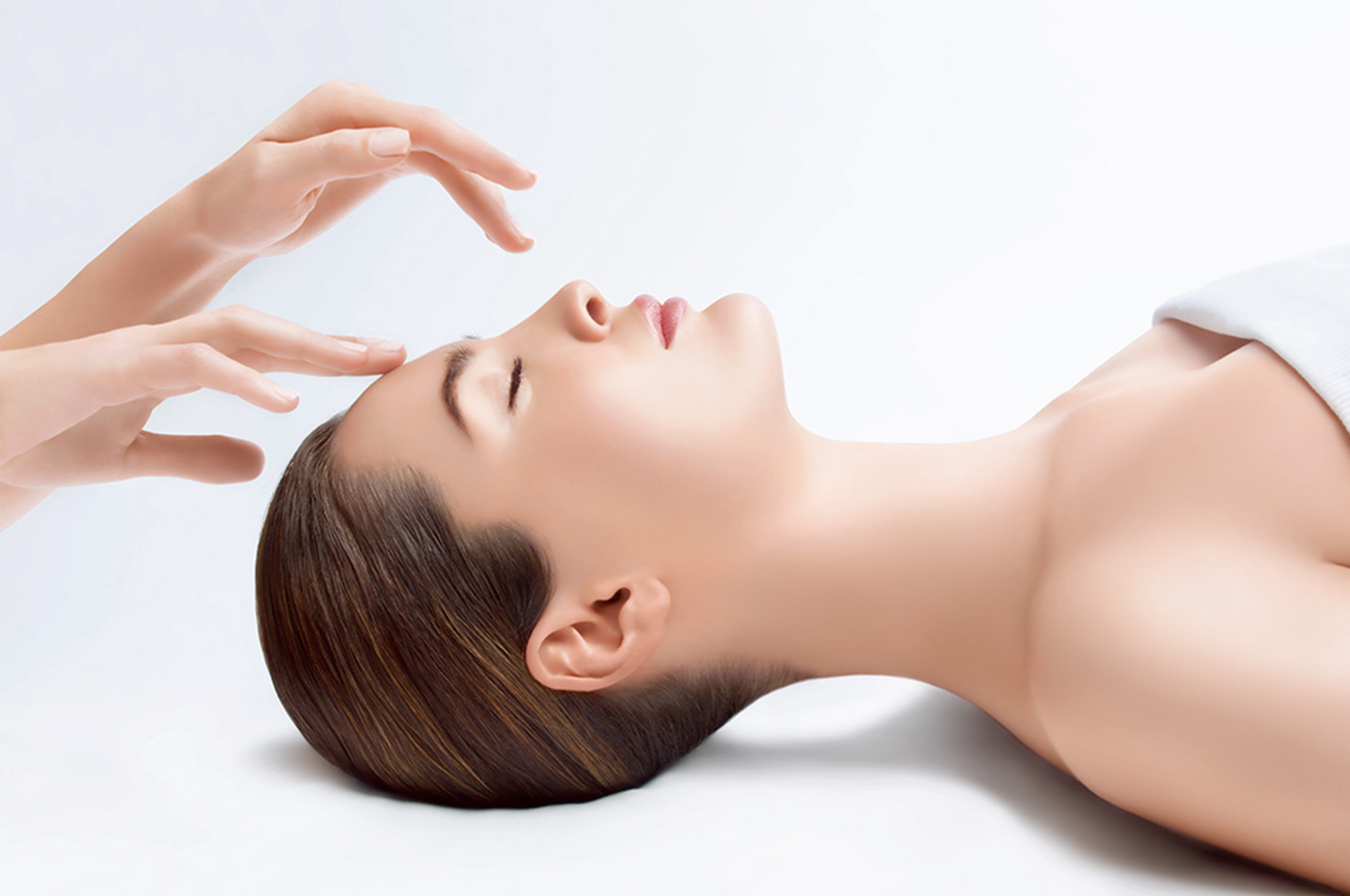 Woman with closed eyes getting a facial massage