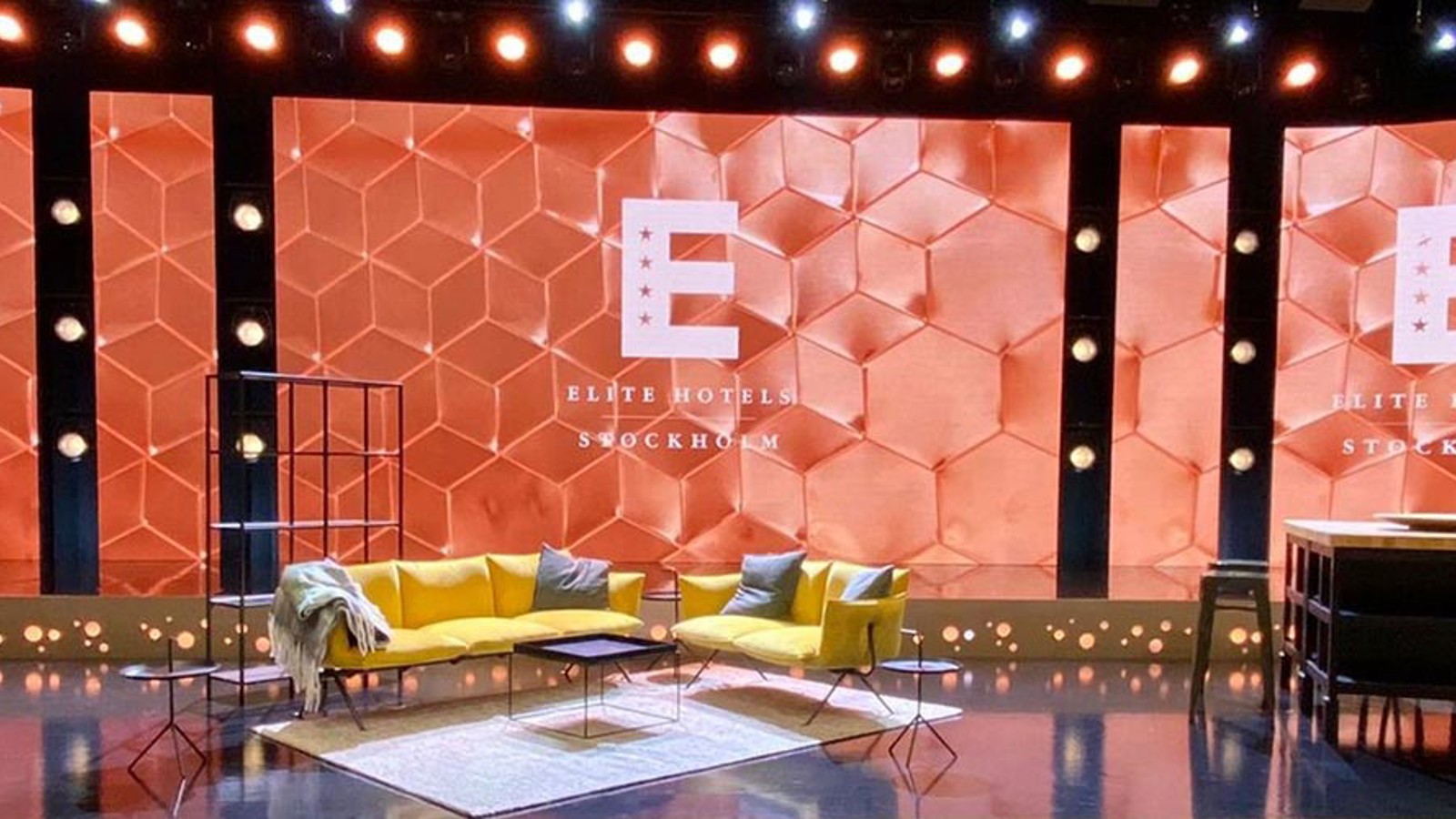 A studio stage at Elite Hotels with couches and chairs