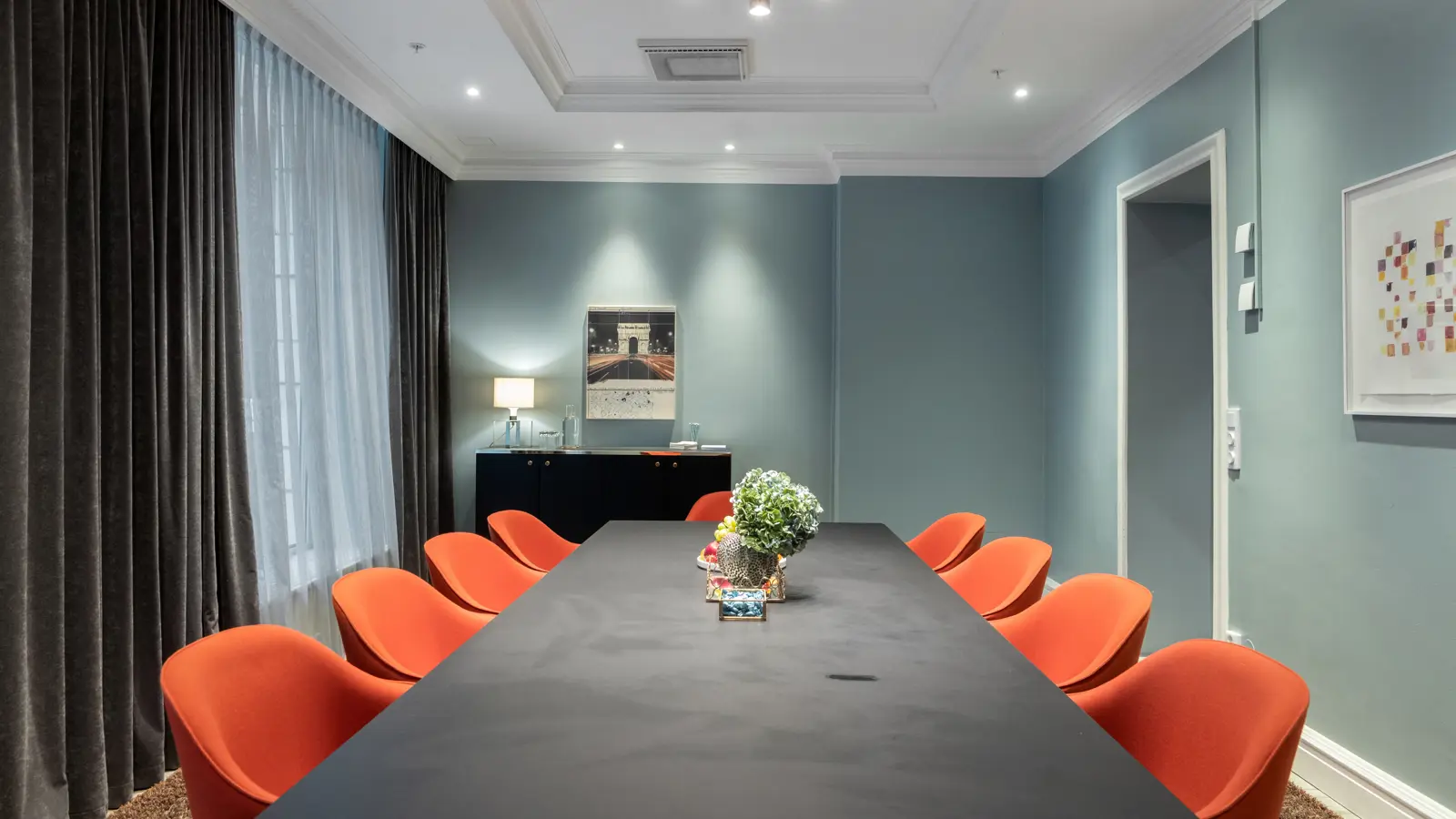 A conference table with water and flowers