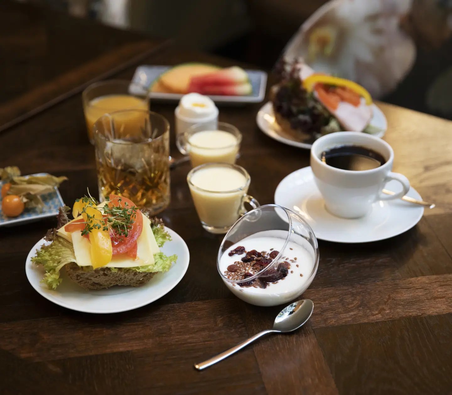 Breakfast with sandwich and coffee laid out on the table