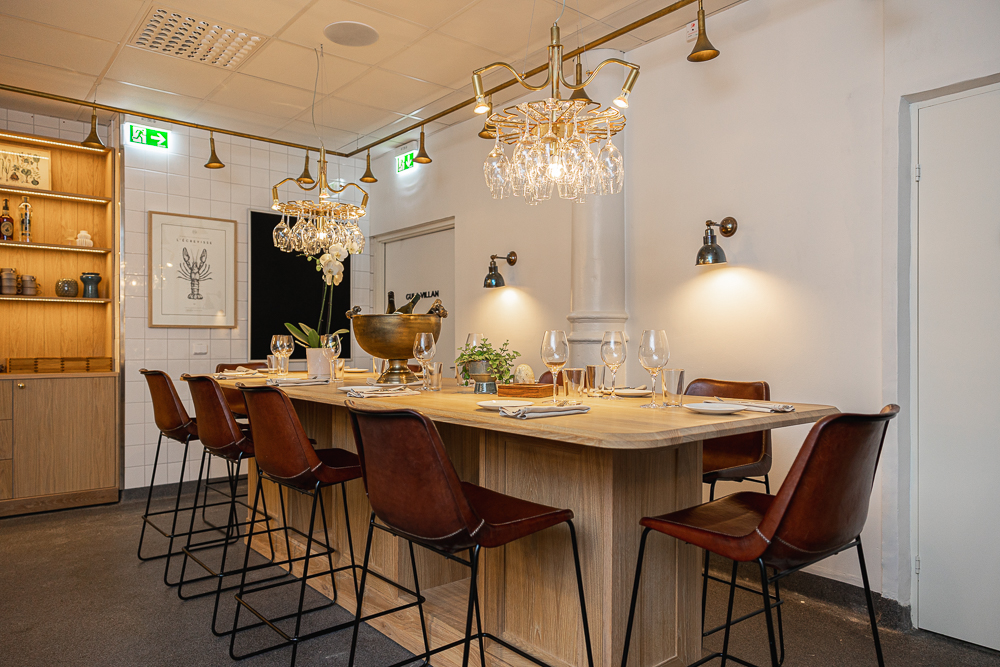 High chairs around table with table setting and wine