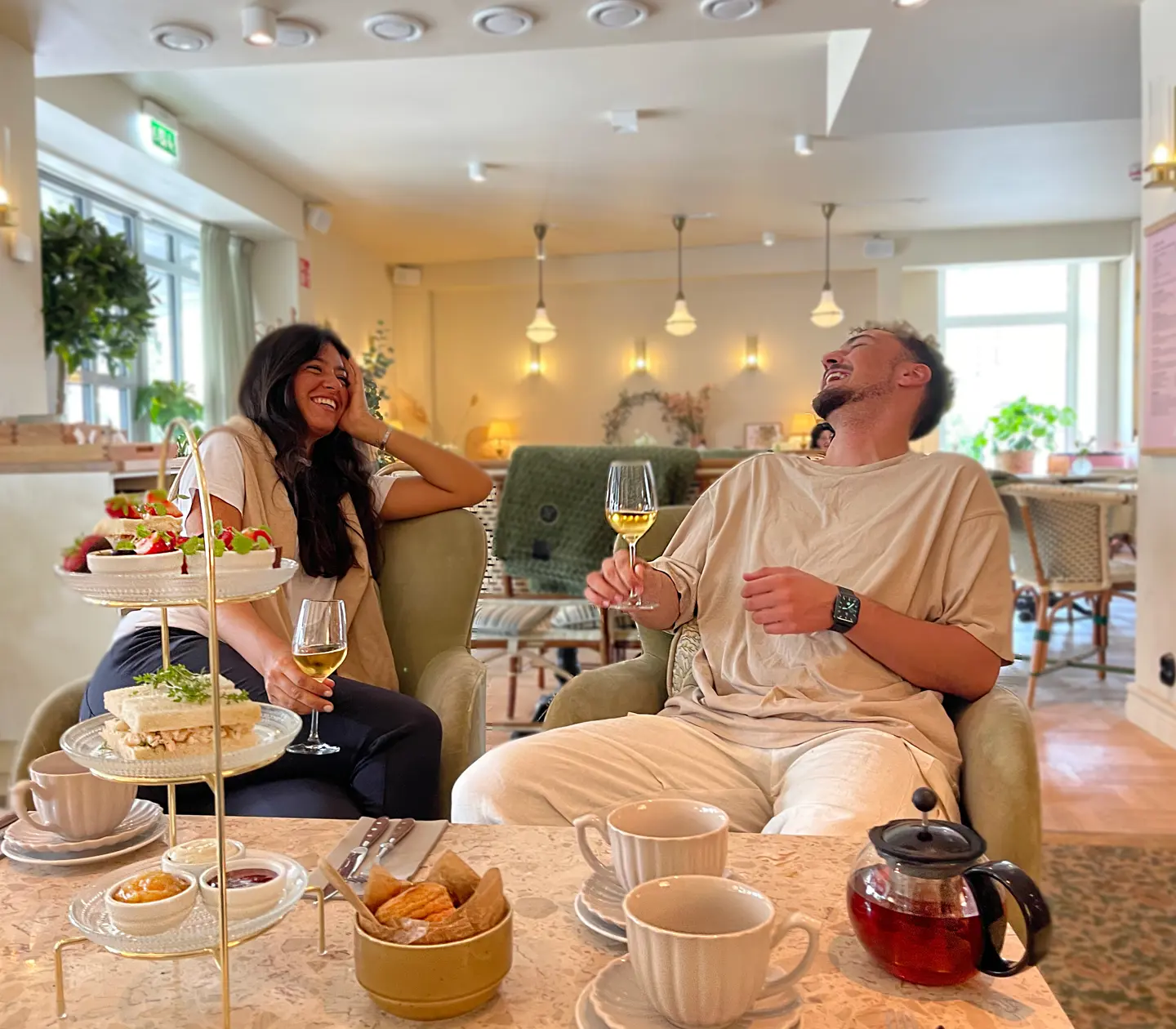 Skrattande kvinna och man på café