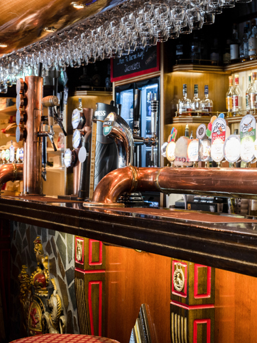 A bar with a large selection of beers on tap