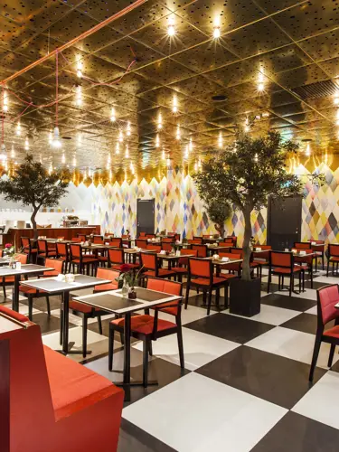 Restaurant with red chairs and checkerboard floor