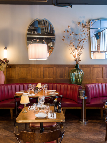 A restaurant furnished with wood and leather seating