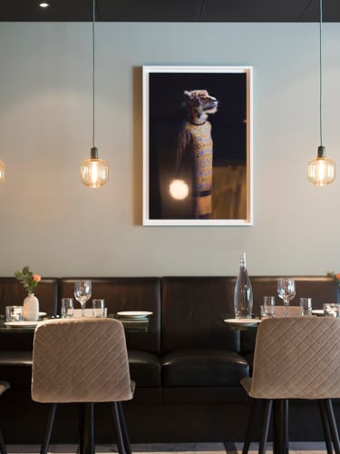 Restaurant interior with black sofas and marble tables