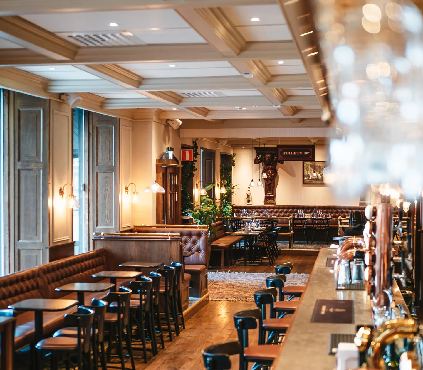 The Bishop's Arms gastropub with a large bar and many seating areas in a classic English pub environment