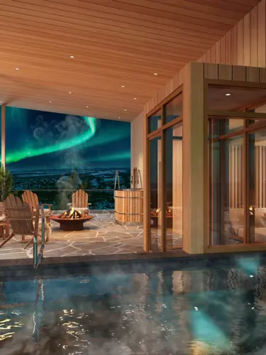Luxurious spa with wooden interior, featuring a hot tub and cozy seating area overlooking the Northern Lights at night.