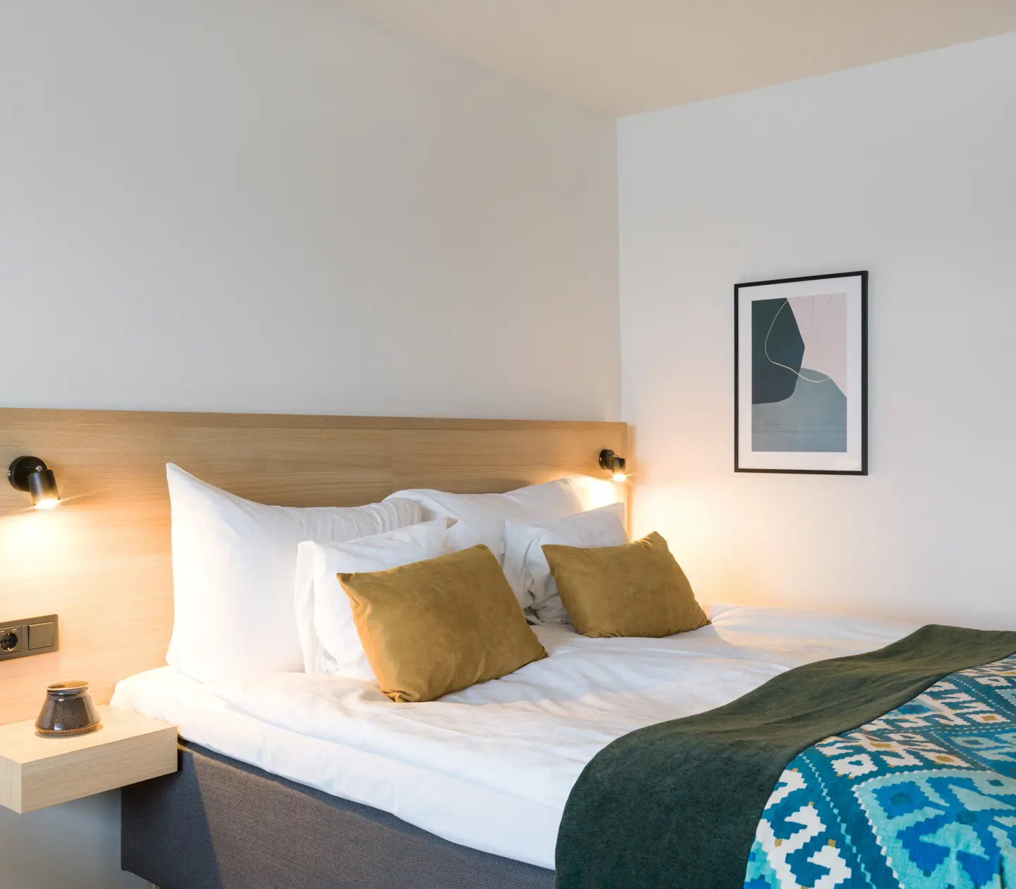 Hotellrum med dubbelsäng och tavla