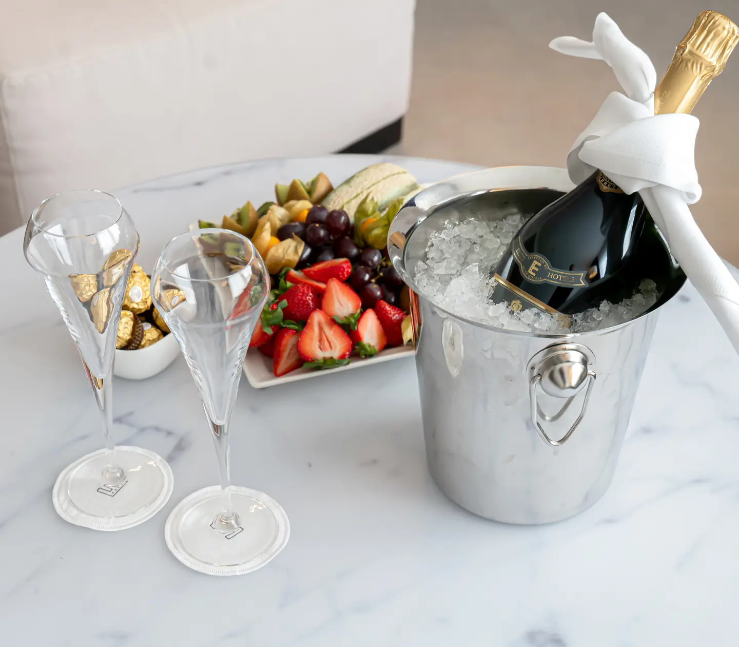 Vip framdukad på bord med champagne, frukt och choklad
