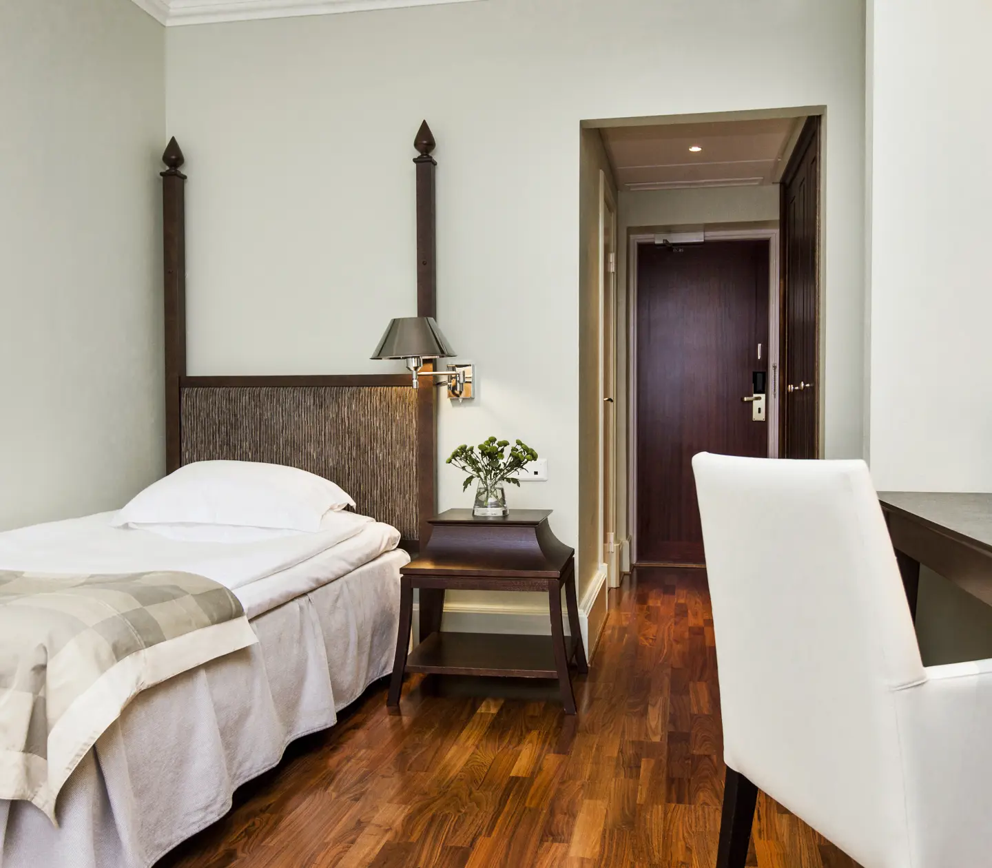 Hotellrum med enkelsäng och skrivbord