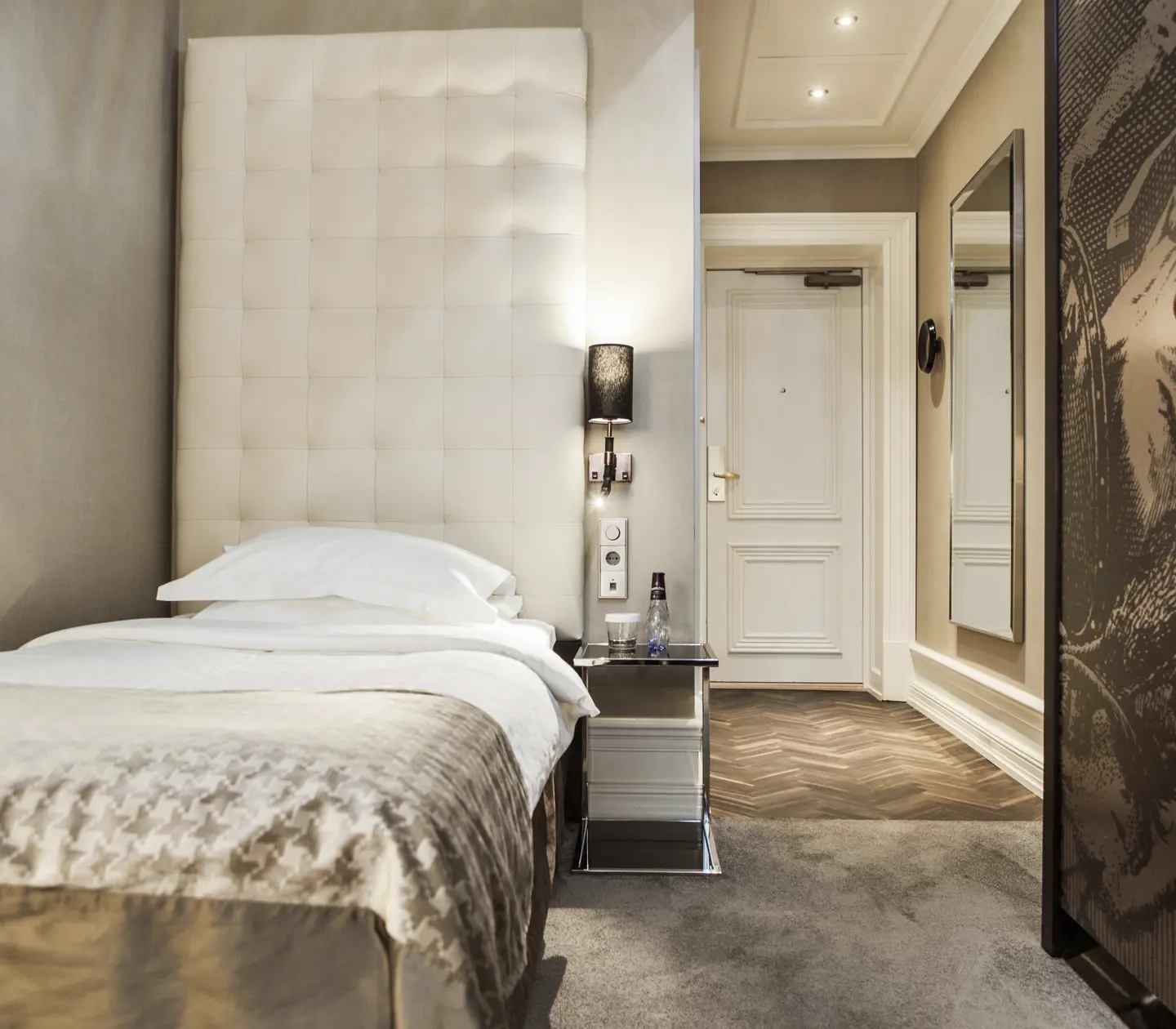 Ljust hotellrum med enkelsäng och garderob