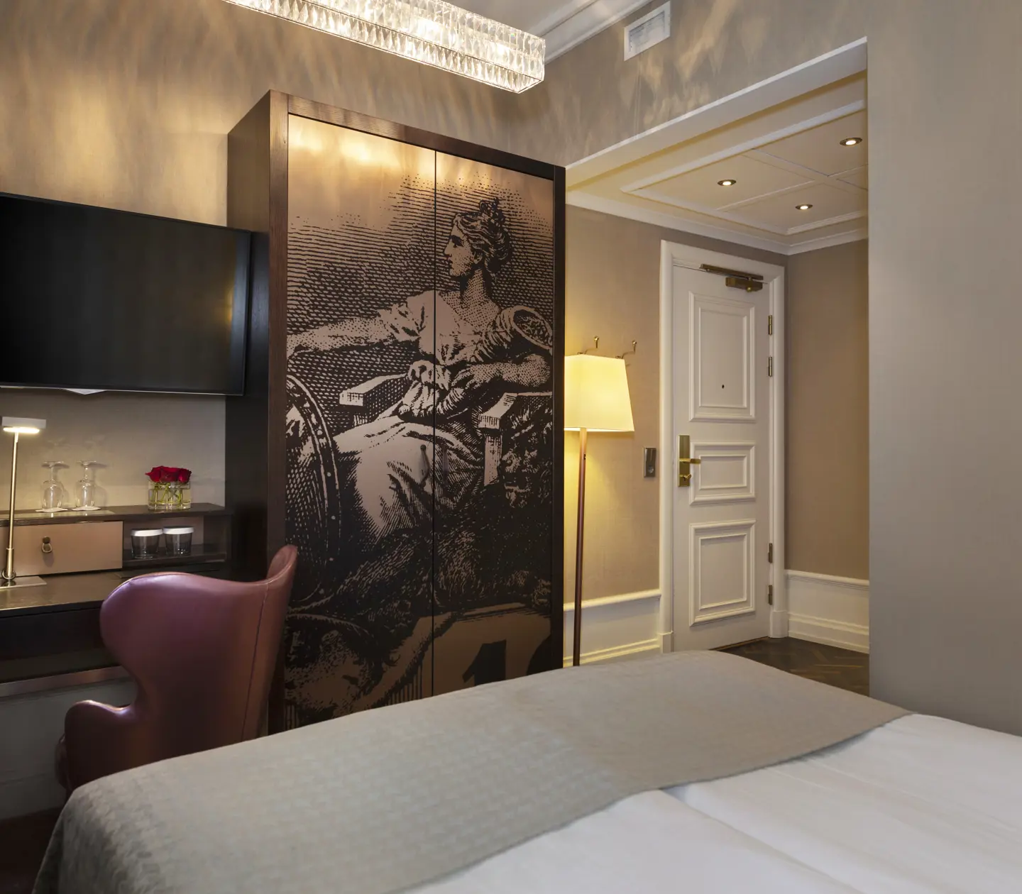 Mysigt hotellrum med säng, tv och garderob