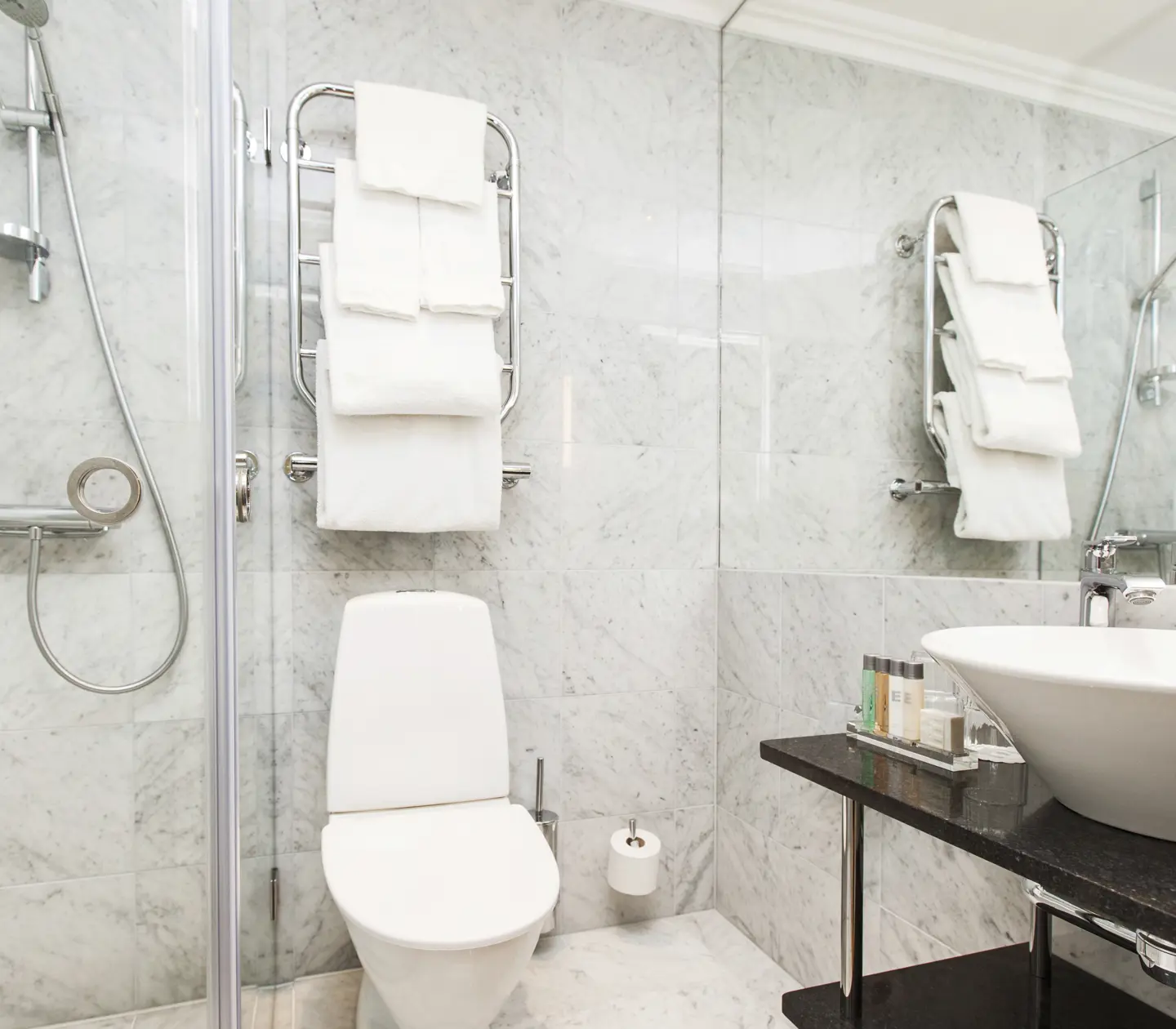Bright bathroom with sink, toilet and shower