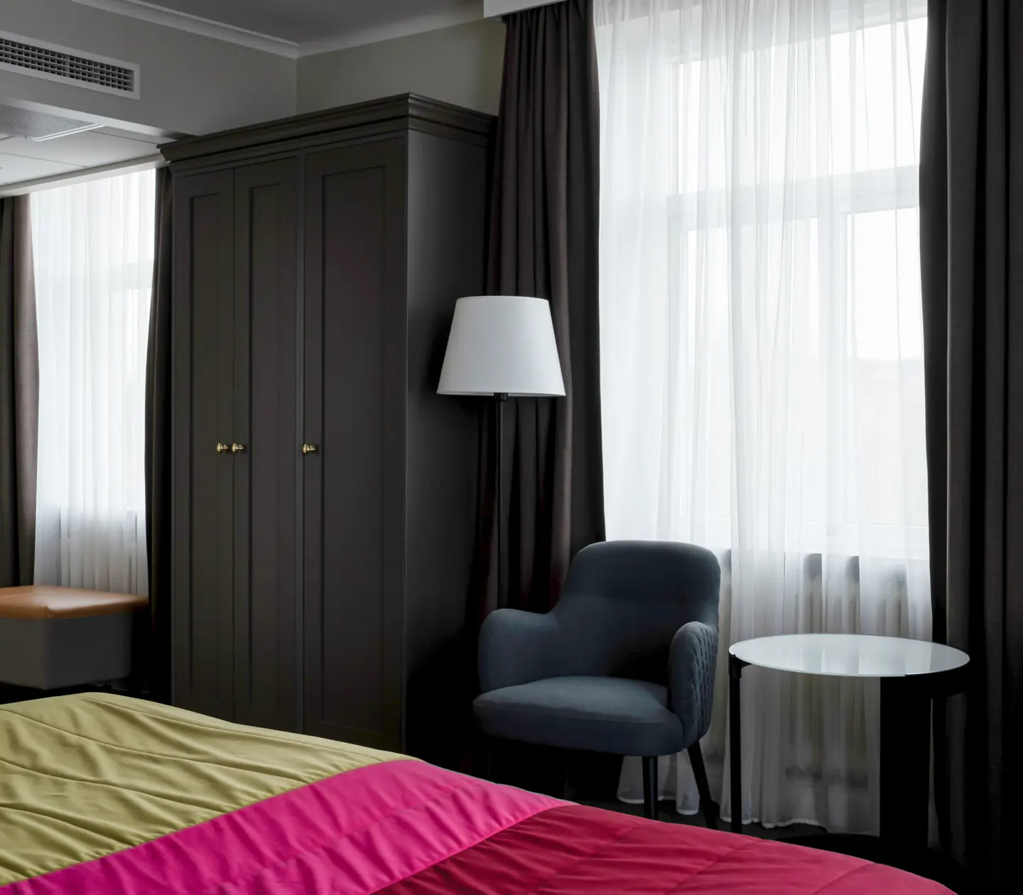 Hotellrum med säng, garderob och fönster