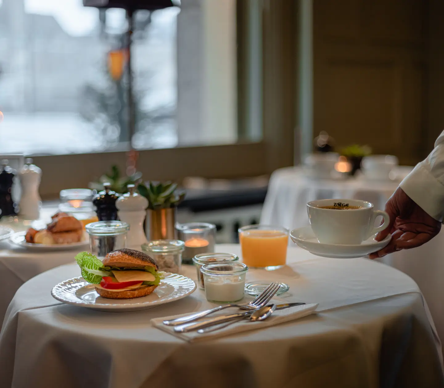 Frukost uppdukad på bord och kaffe som serveras till bordet