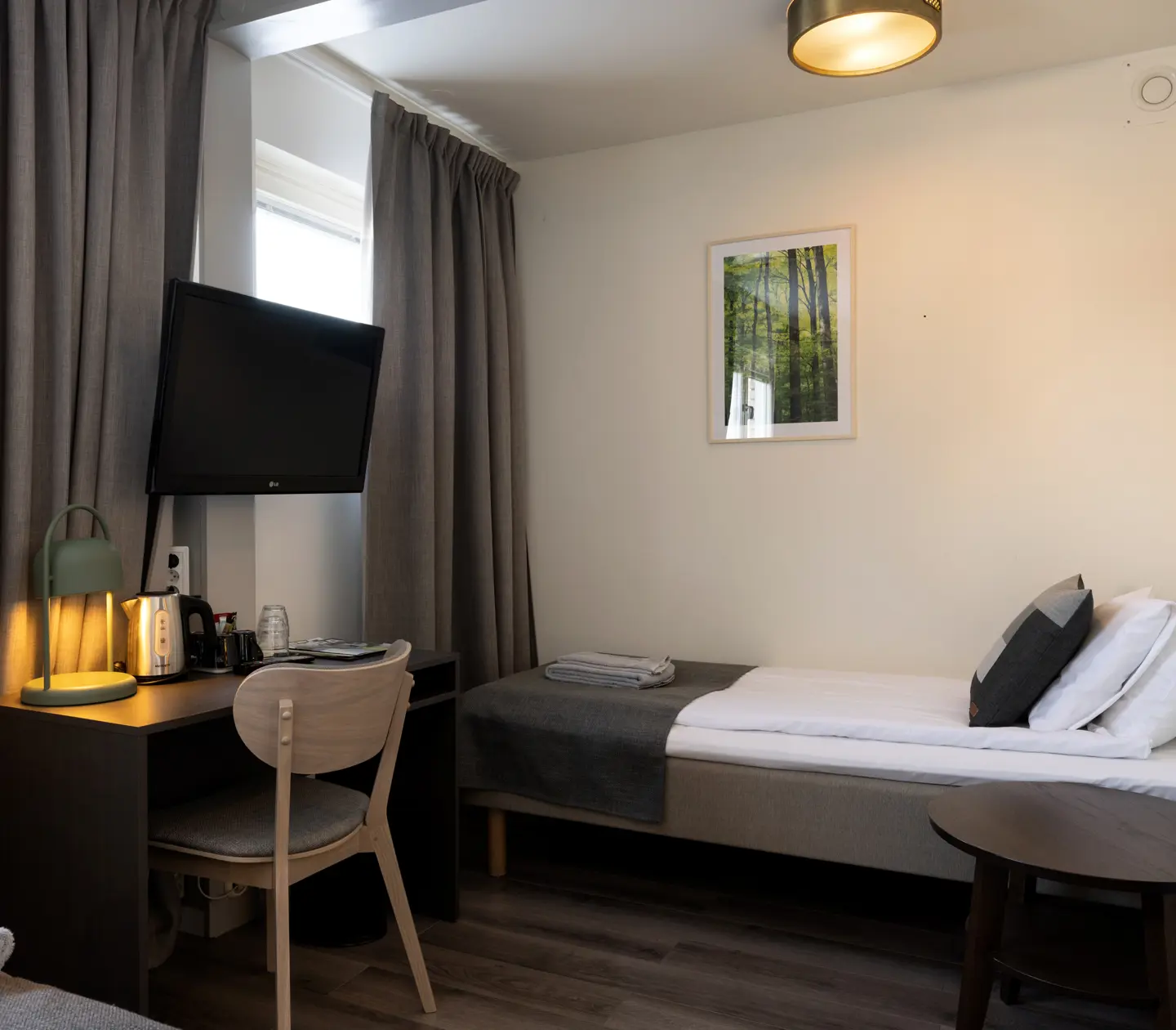 Hotellrum med sängar, skrivbord och tv