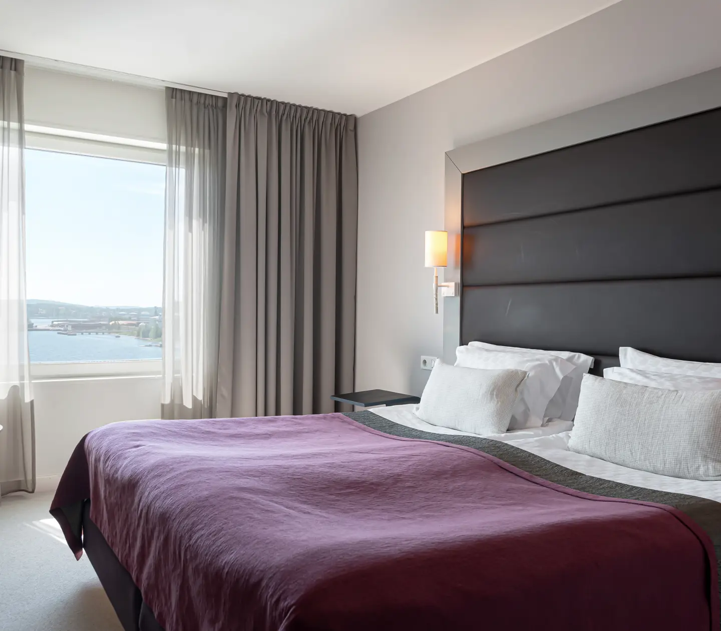 Hotellrum med dubbelsäng och fönster med havsutsikt
