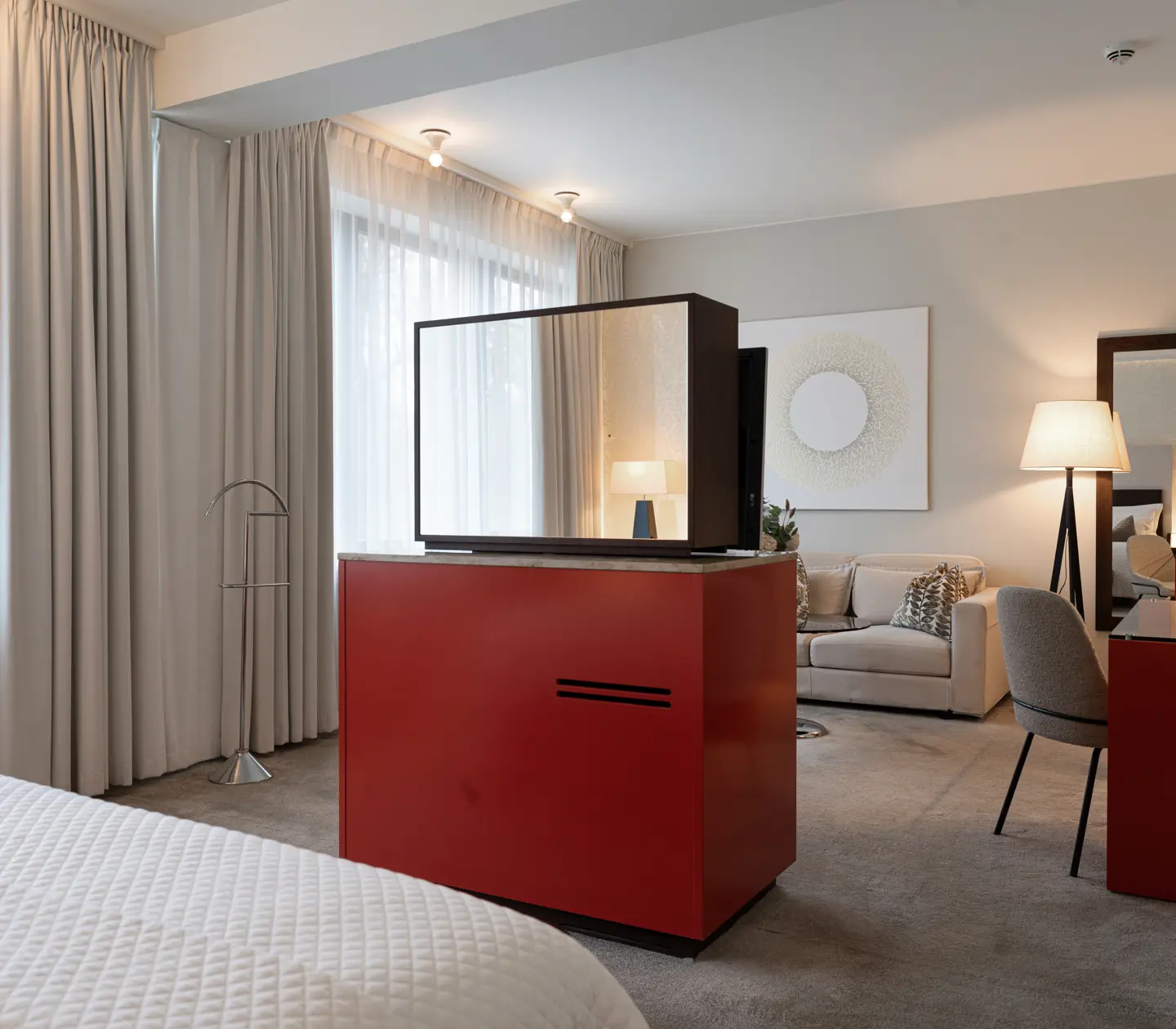Bright hotel room with bed, bedside table and bedside lamps