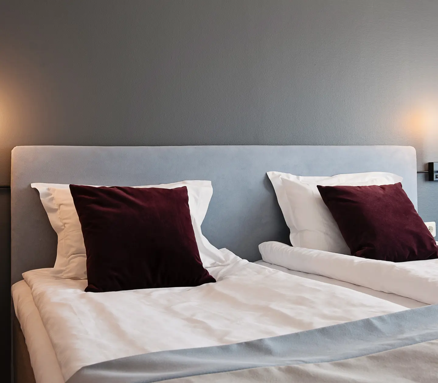 Mysigt hotellrum med dubbelsäng och sänglampor