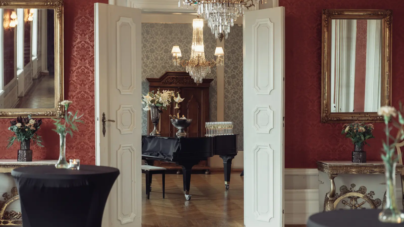 Närbild av en elegant kristallkrona med gulddetaljer som reflekterar ljus.